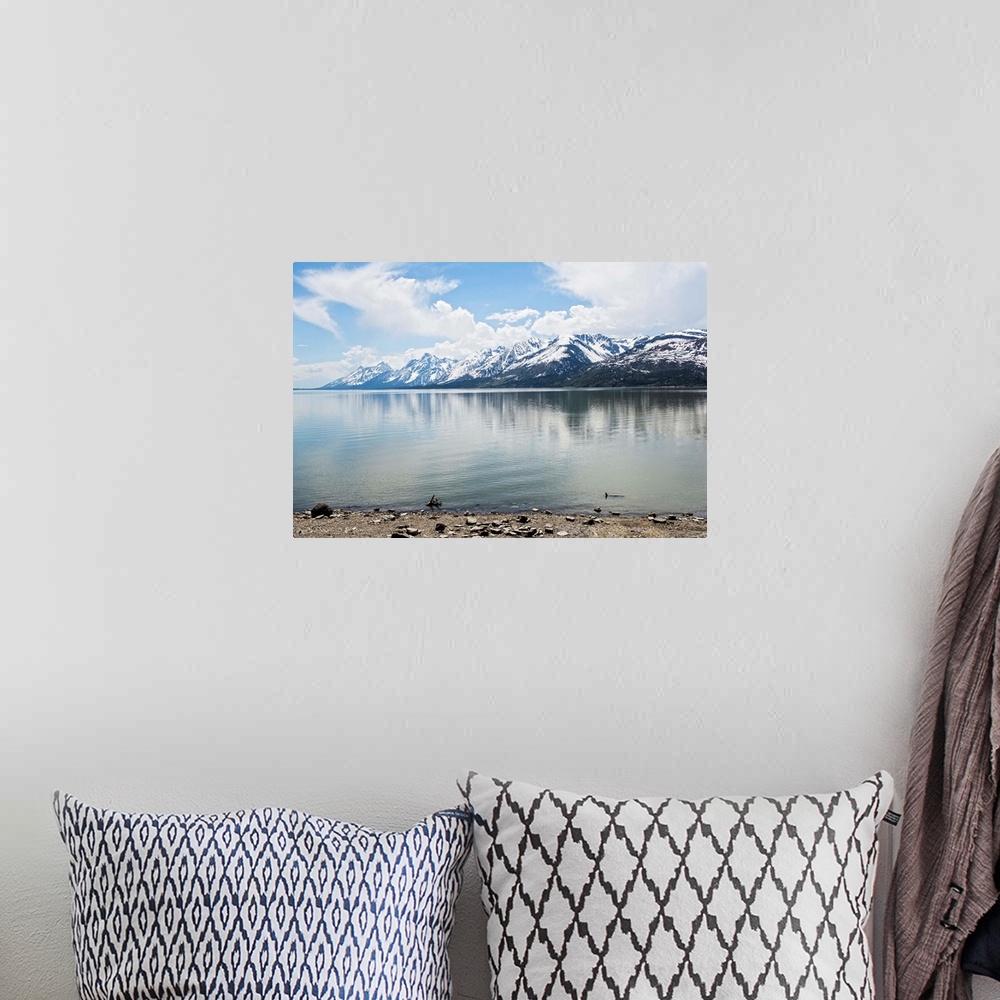 A bohemian room featuring Landscape photograph of Jackson Lake with the Grand Teton mountains in the background.