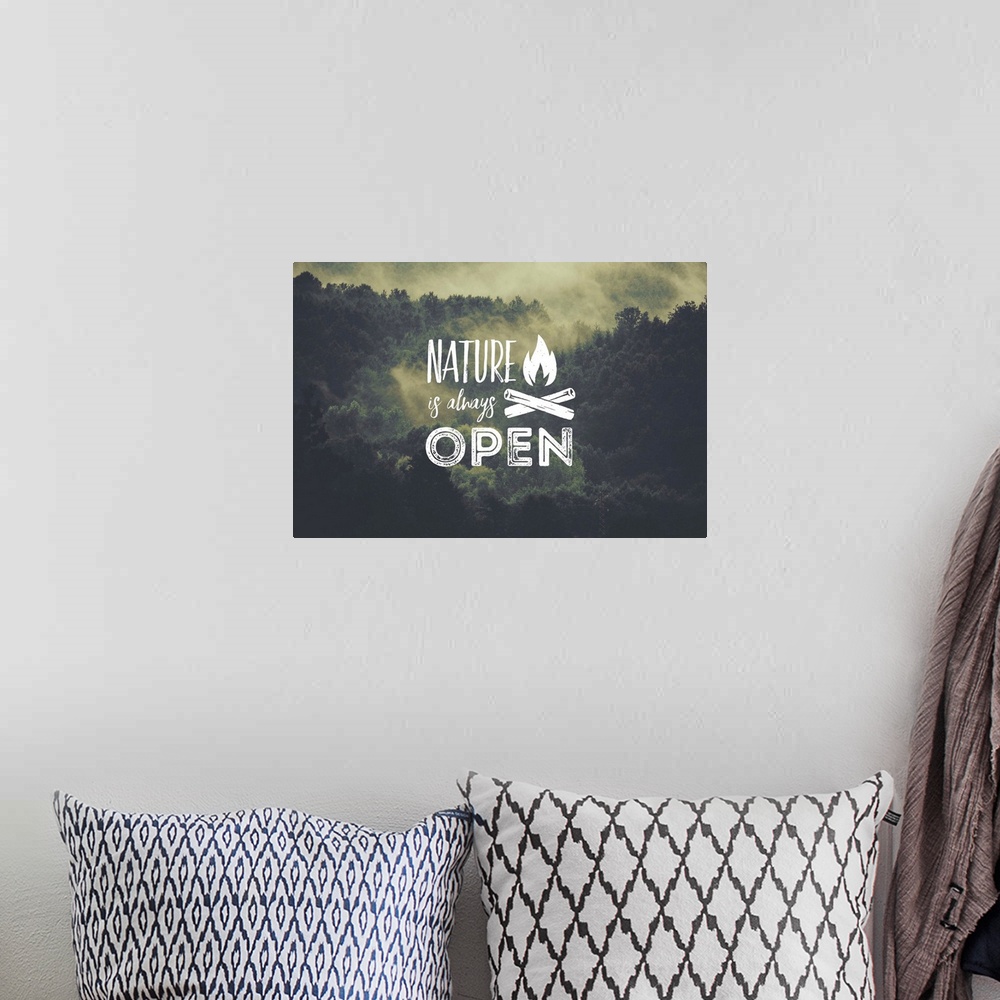 A bohemian room featuring Typography art against a photograph of a forest scene covered in fog.