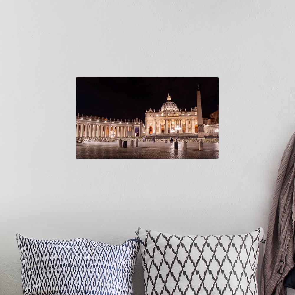A bohemian room featuring Photograph of St. Peter's Basilica at St. Peter's Square in Vatican City at night.