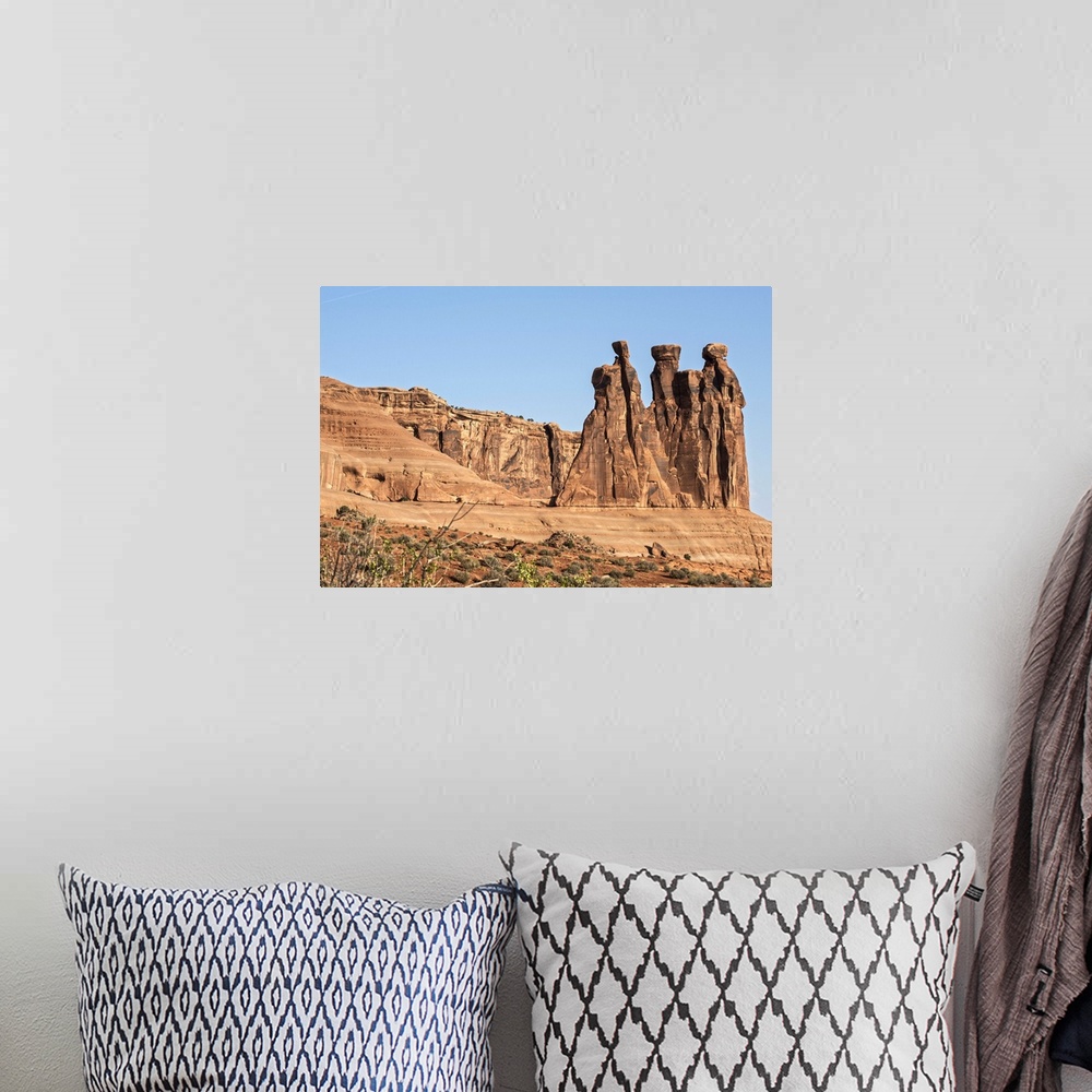 A bohemian room featuring The Three Gossips, sandstone formation in the Courthouse Towers area of Arches National Park, Moa...