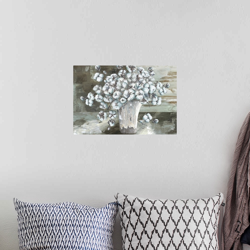 A bohemian room featuring A decorative painting of a vase full of white cotton balls in subdue tones.