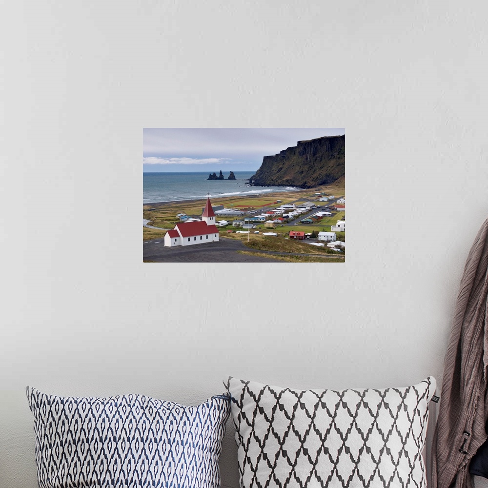 A bohemian room featuring Church, village of Vik and Reynisdrangar sea stacks in the distance, Iceland