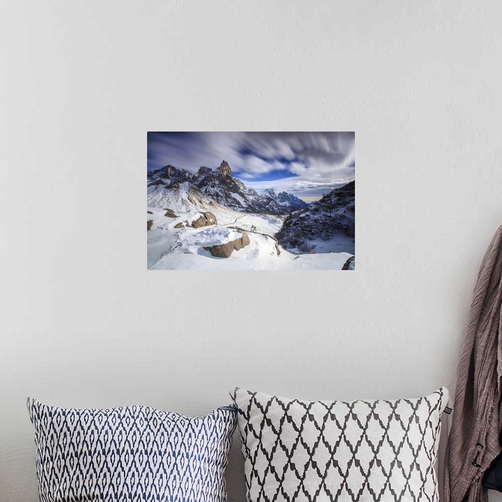 A bohemian room featuring Cloudy winter sky on the snowy peaks of the Pale di San Martino, Rolle Pass, Panaveggio, Dolomite...