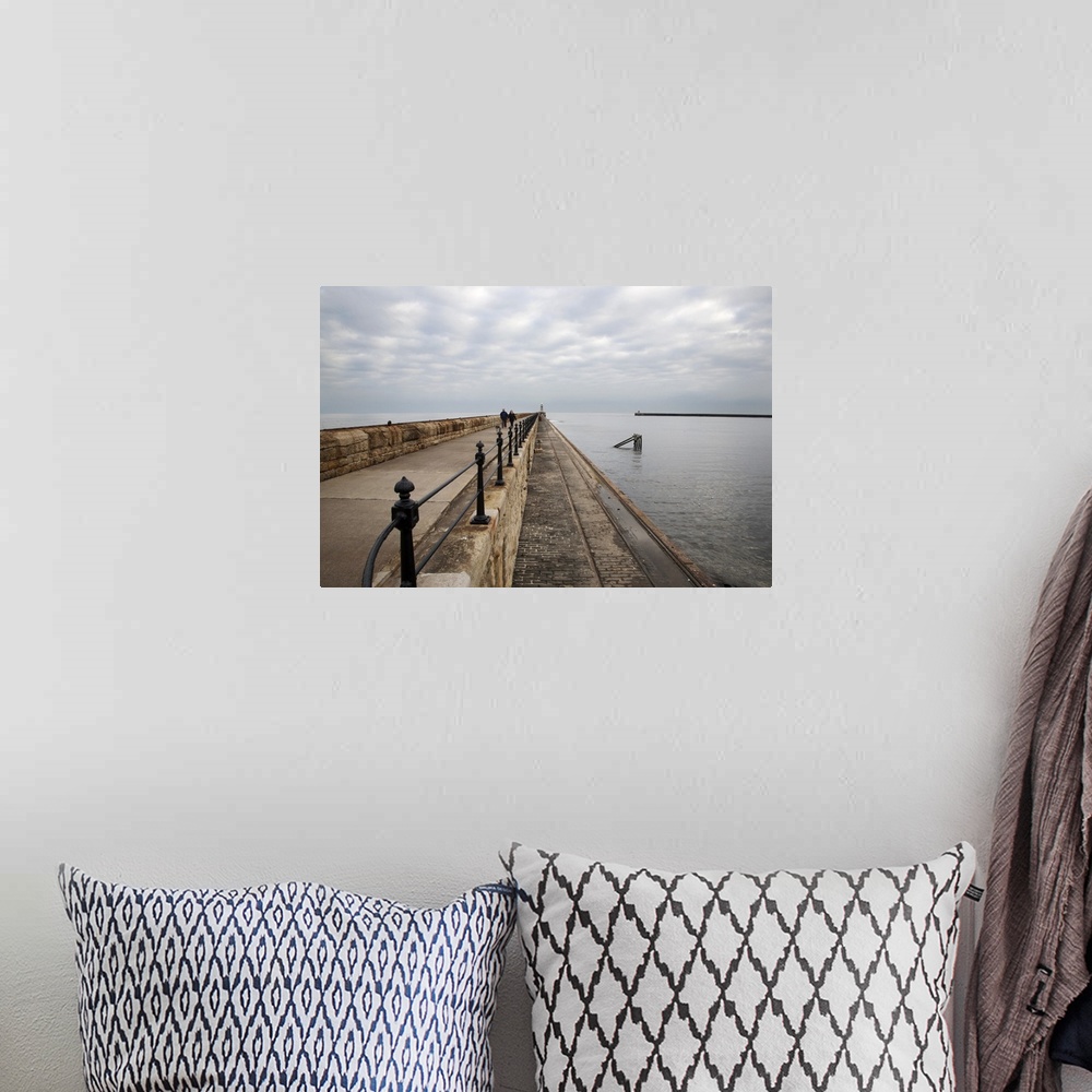 A bohemian room featuring Couple walking on the North Pier at Tynemouth, North Tyneside, Tyne and Wear, England