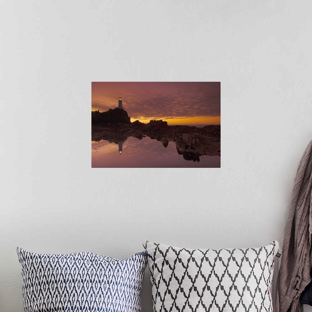 A bohemian room featuring Dramatic sunset and low tide, Corbiere lighthouse, St. Ouens, Jersey, Channel Islands