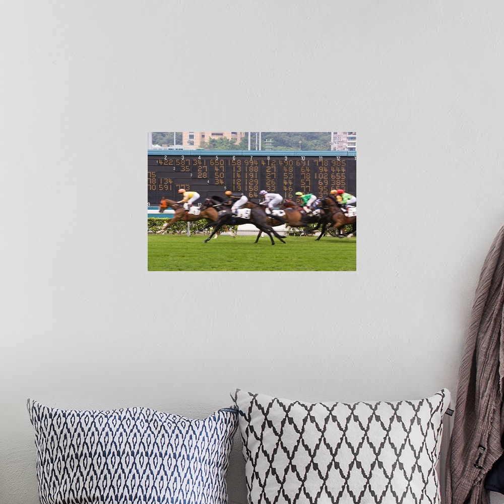 A bohemian room featuring Horses race past large scoreboard during race at Happy Valley racecourse, Hong Kong