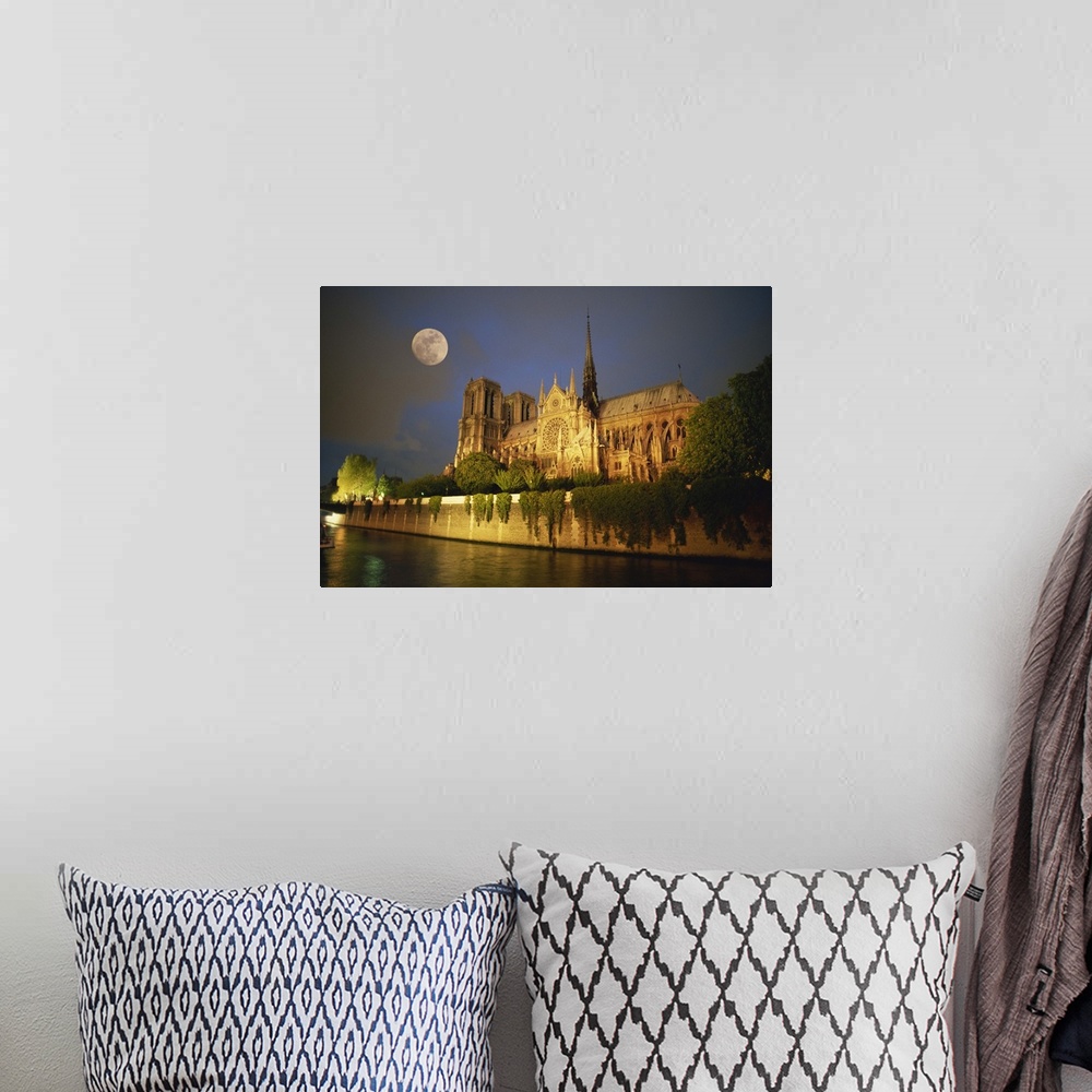 A bohemian room featuring Notre Dame Cathedral at night, with moon rising above, Paris, France, Europe