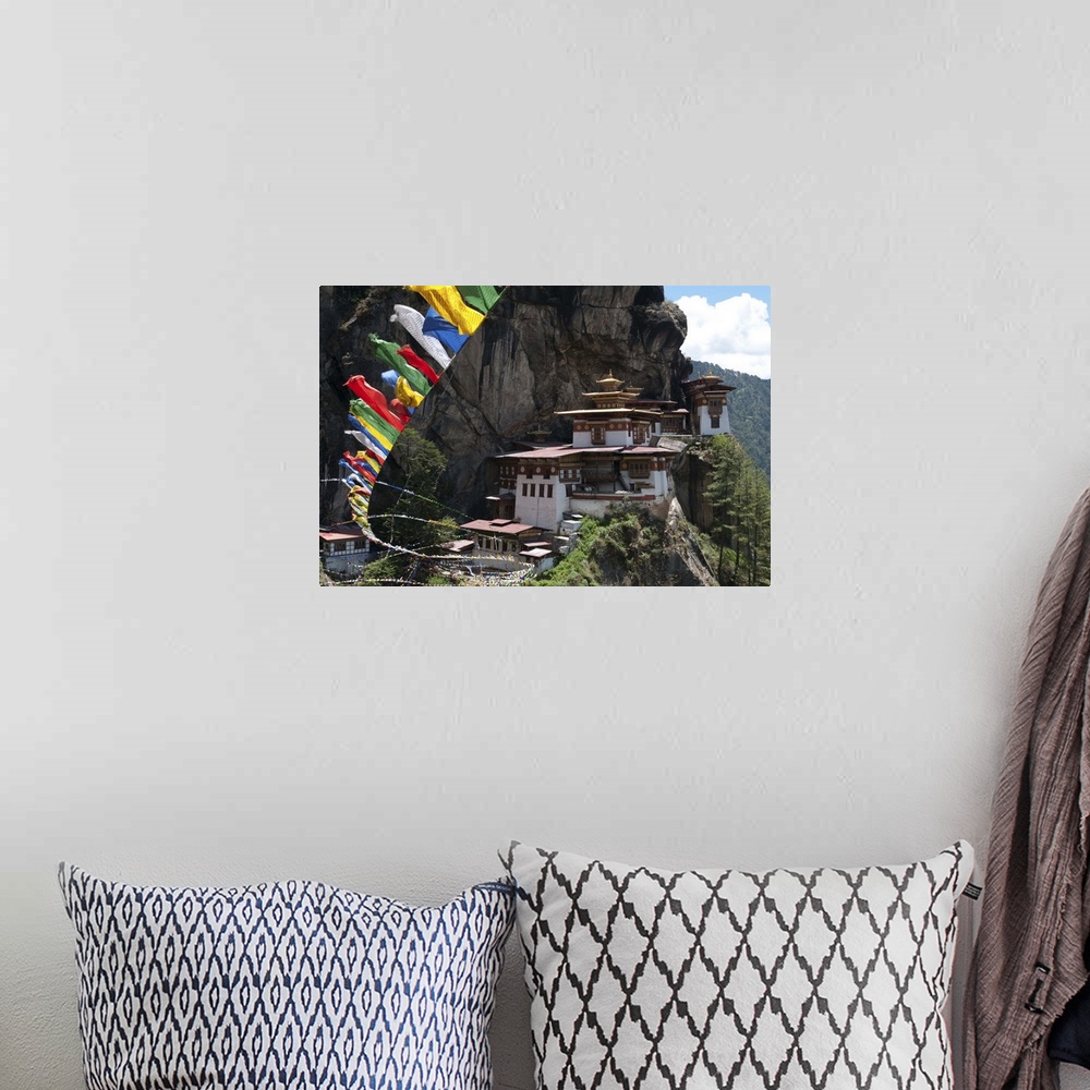 A bohemian room featuring Taktshang Goemba with prayer flags and cliff, Paro Valley, Bhutan
