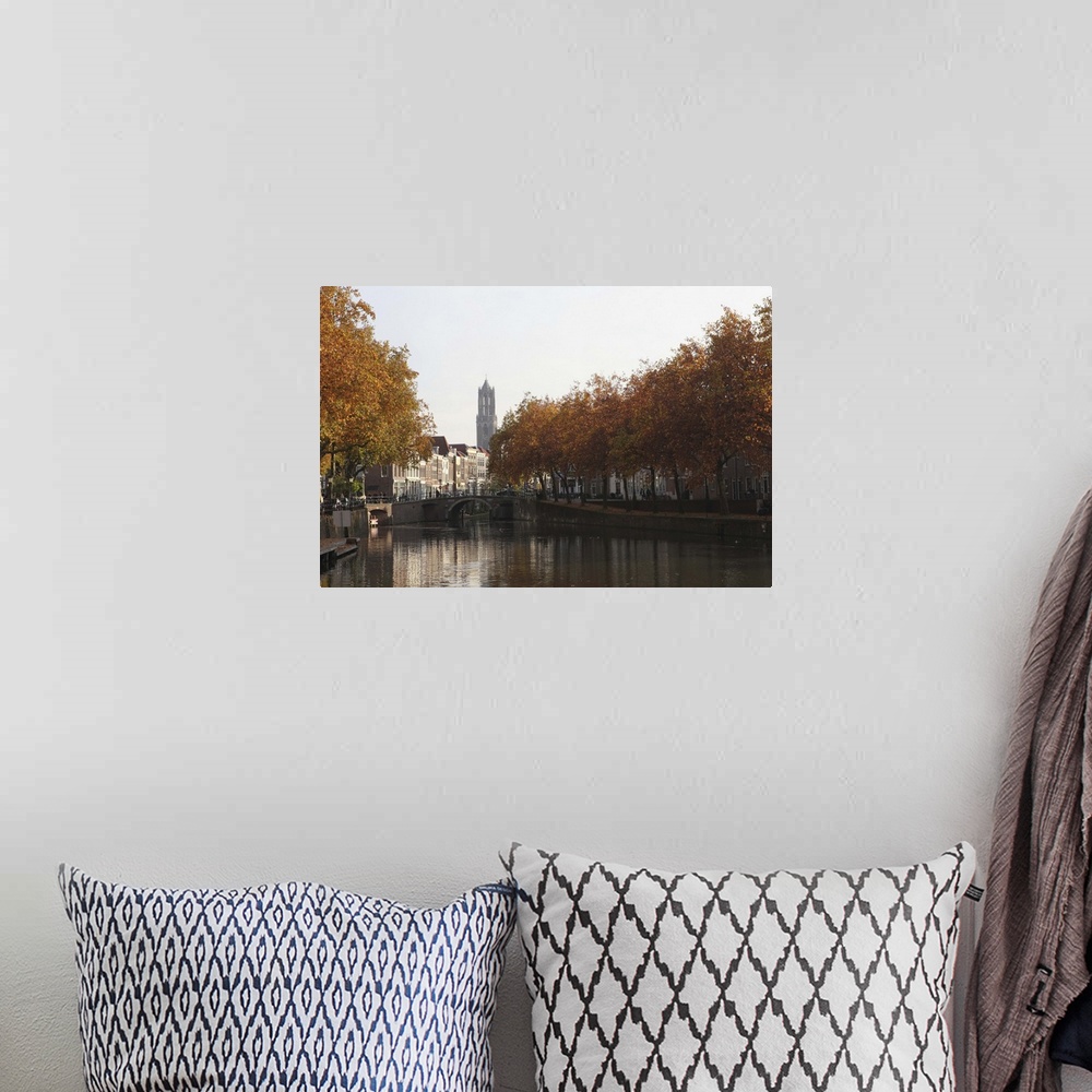 A bohemian room featuring The Dom Tower and canal waterway on an autumn day, Utrecht, Netherlands