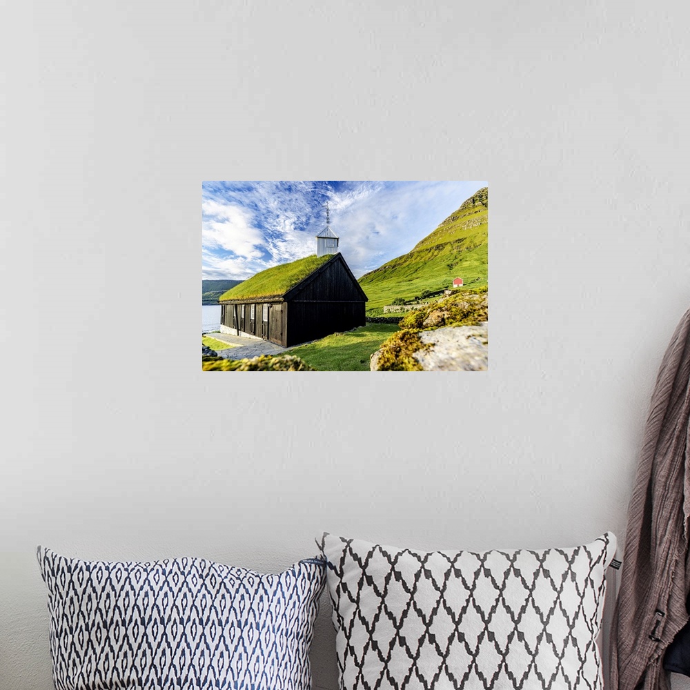 A bohemian room featuring Traditional church with grass roof overlooking the fjord, Funningur, Eysturoy Island, Faroe Islan...