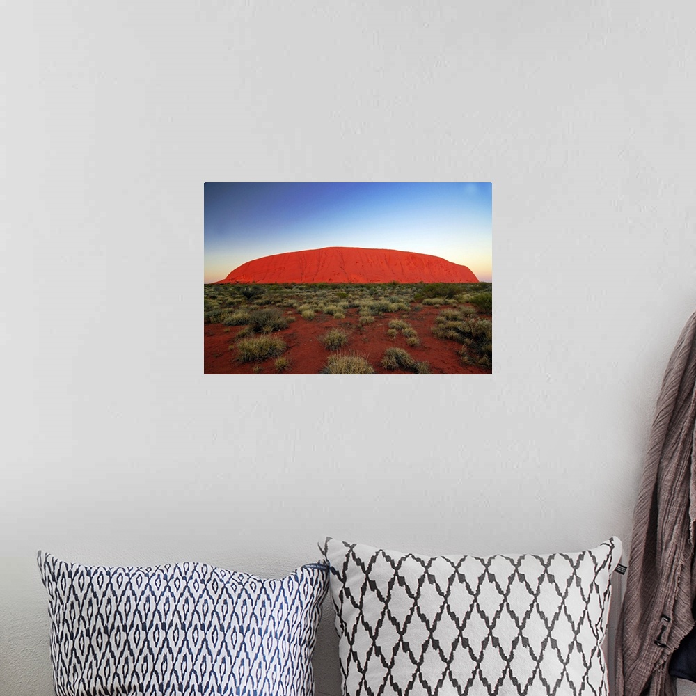 A bohemian room featuring Uluru (Ayers Rock) at sunrise. Uluru is a large sandstone rock formation in the southern part of ...