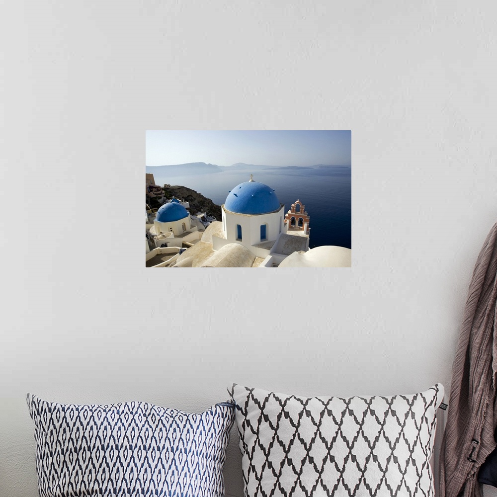 A bohemian room featuring Photograph taken on the coast of Greece looking out toward the water with blue domed churches sit...