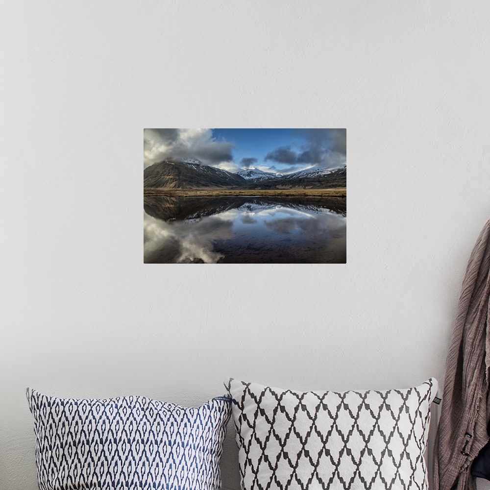 A bohemian room featuring Snow covered mountain reflecting in a lake in Iceland.