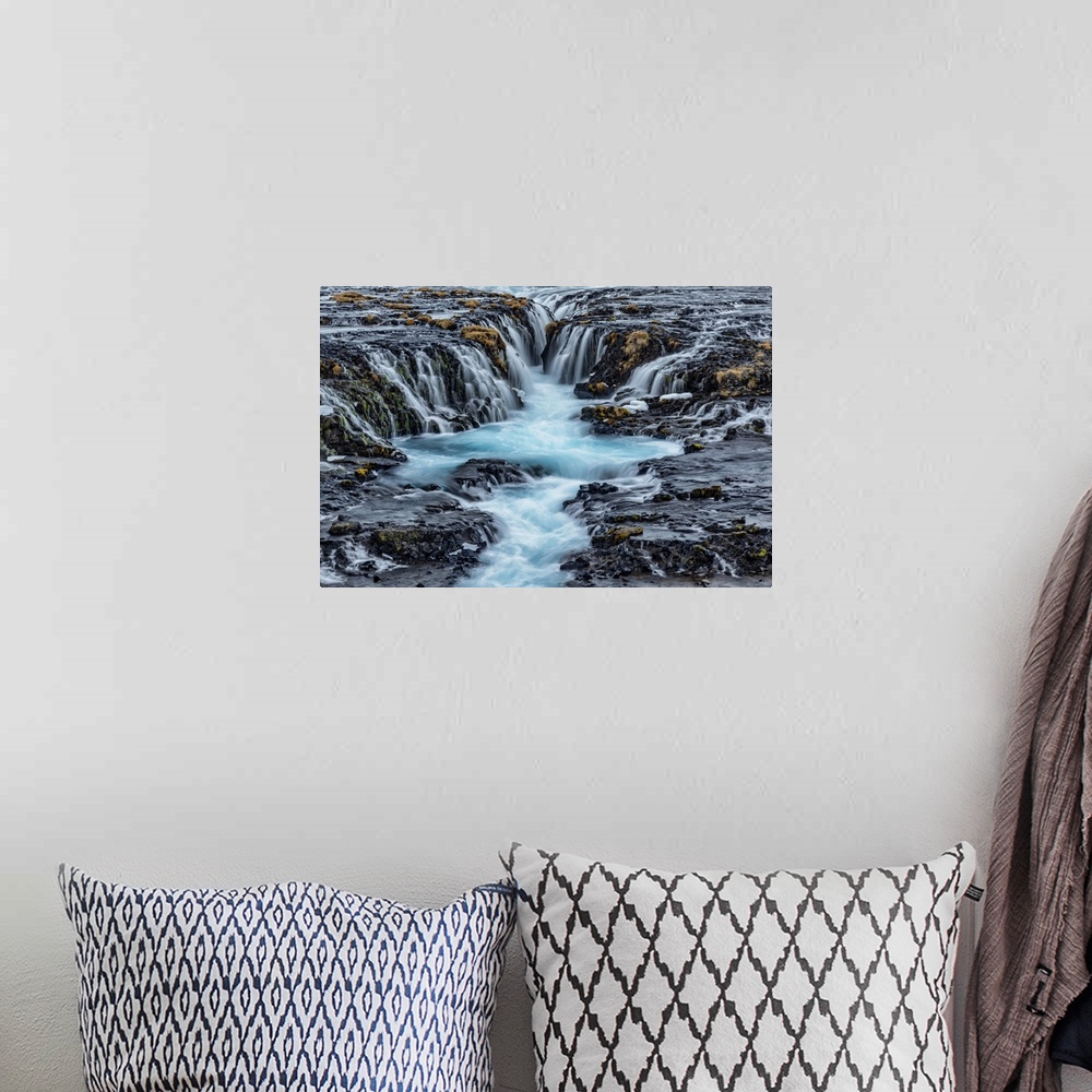 A bohemian room featuring Bruarfoss waterfall in winter in Iceland.