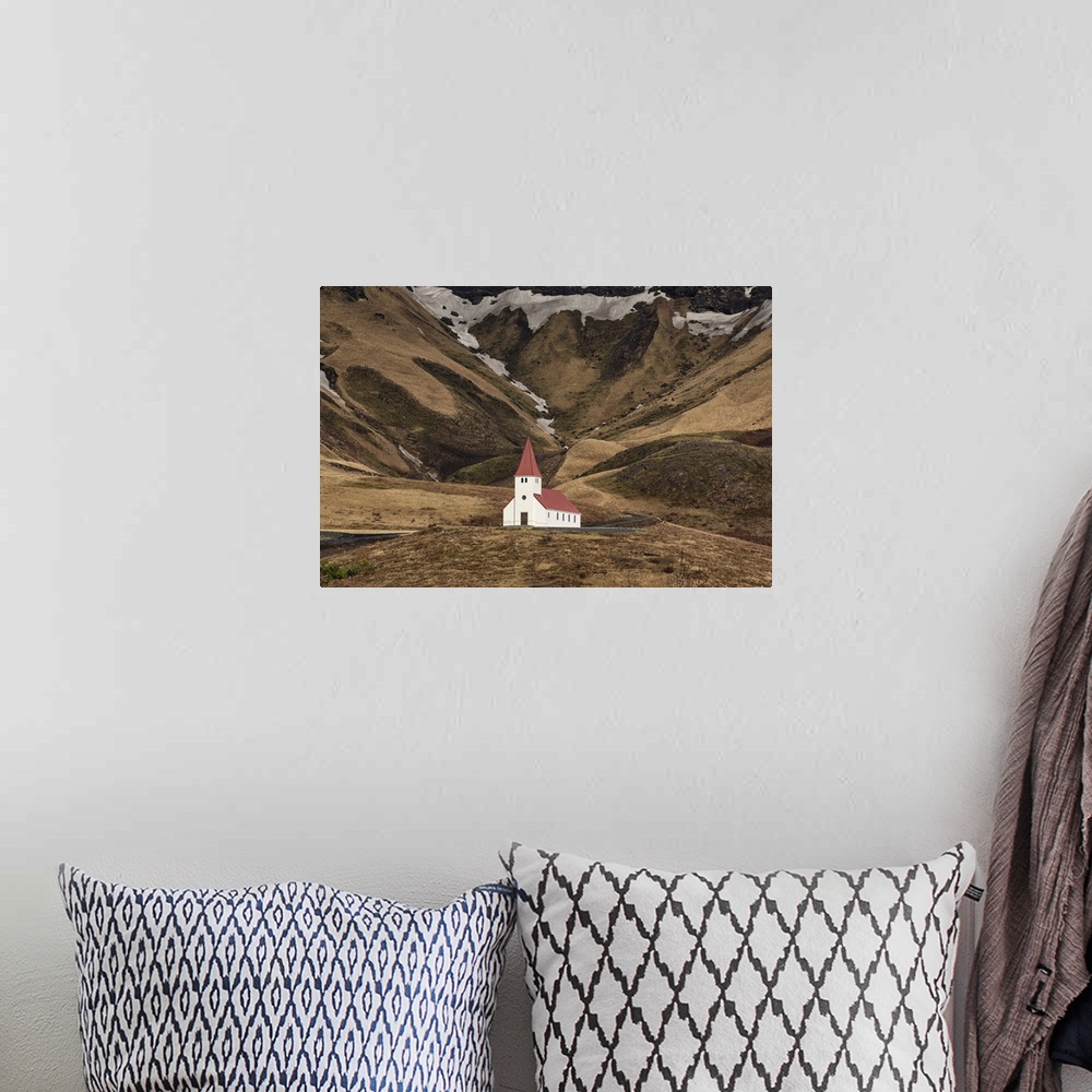 A bohemian room featuring The beautiful church on the hillside in Vik, Iceland.