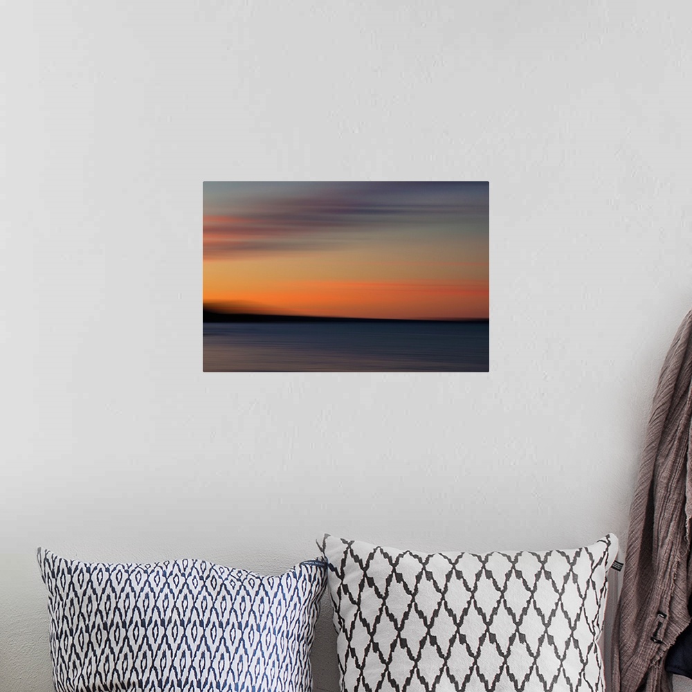 A bohemian room featuring Moody beach scene at sunset.