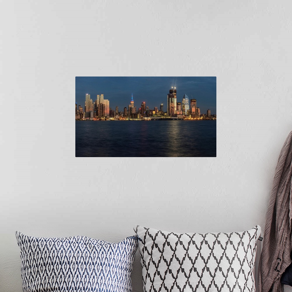 A bohemian room featuring New York City skyline at sunset