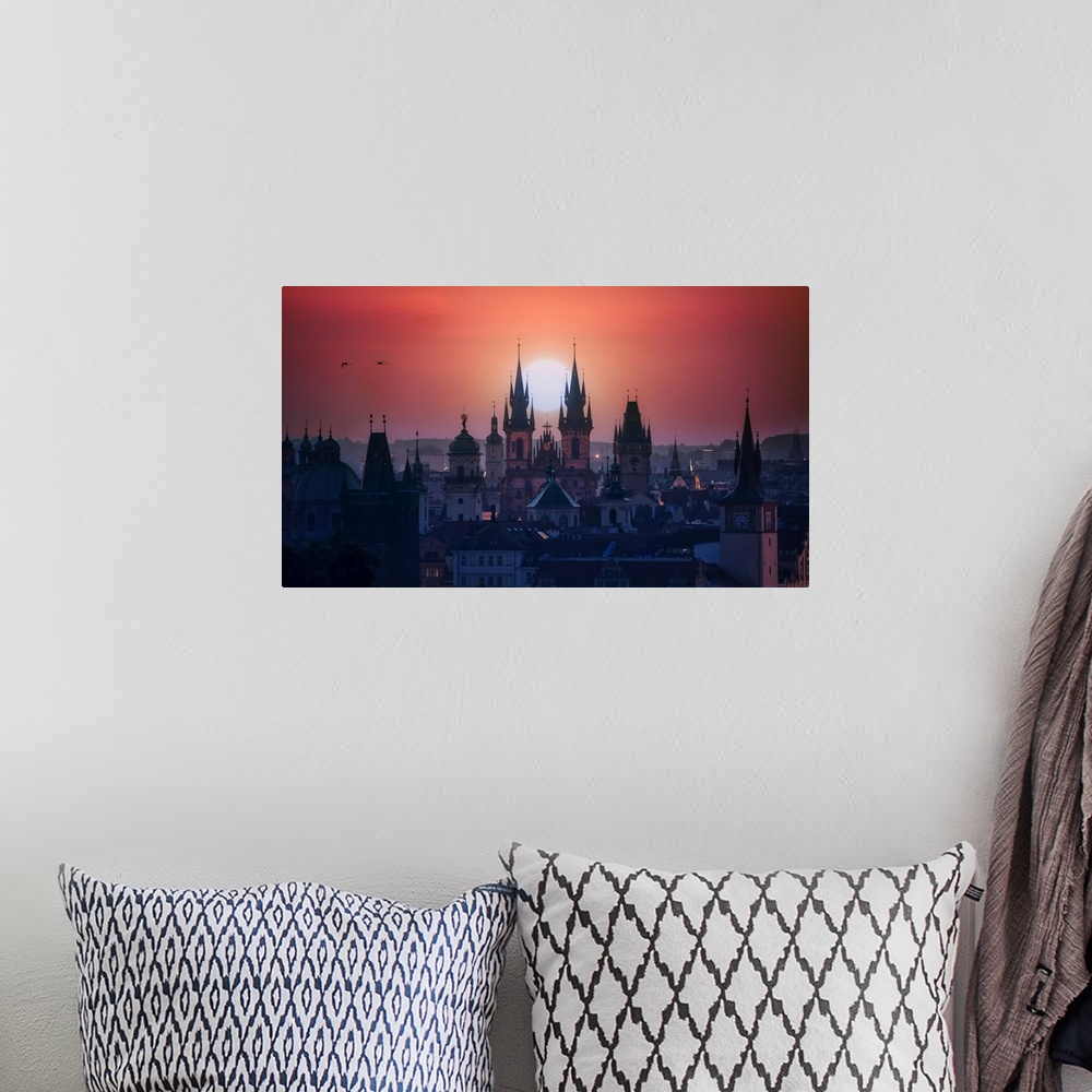 A bohemian room featuring The towers of beautiful Prague at sunrise.