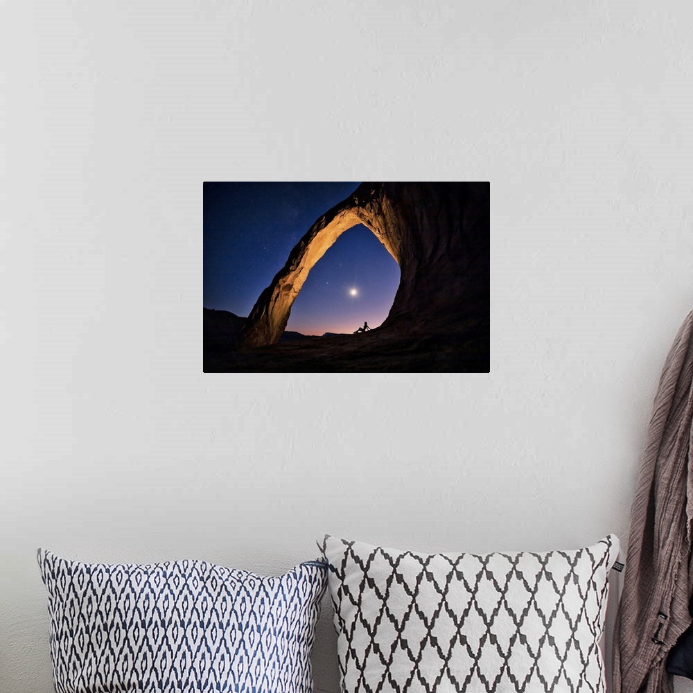 A bohemian room featuring Silhouette of a woman under Corona Arch in Moab, Utah
