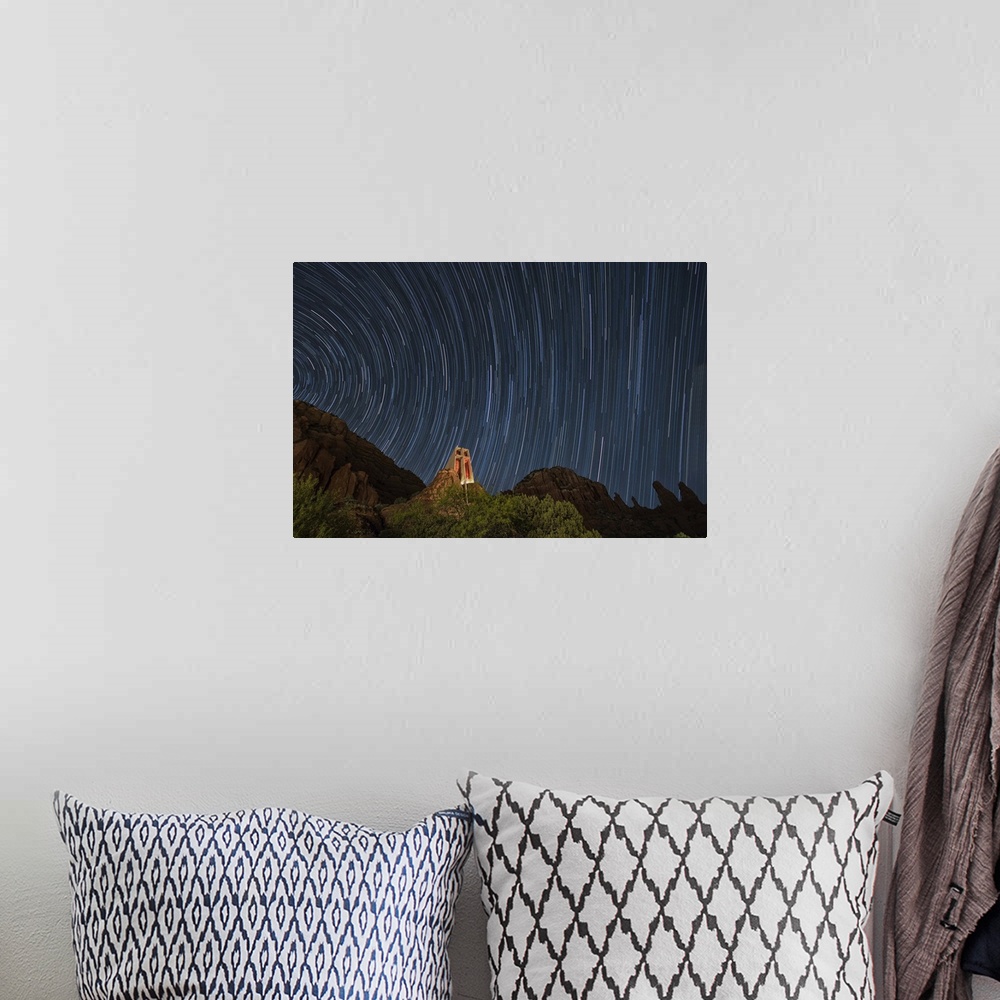 A bohemian room featuring Star trails above the Chapel of the Holy Cross in Sedona, Arizona