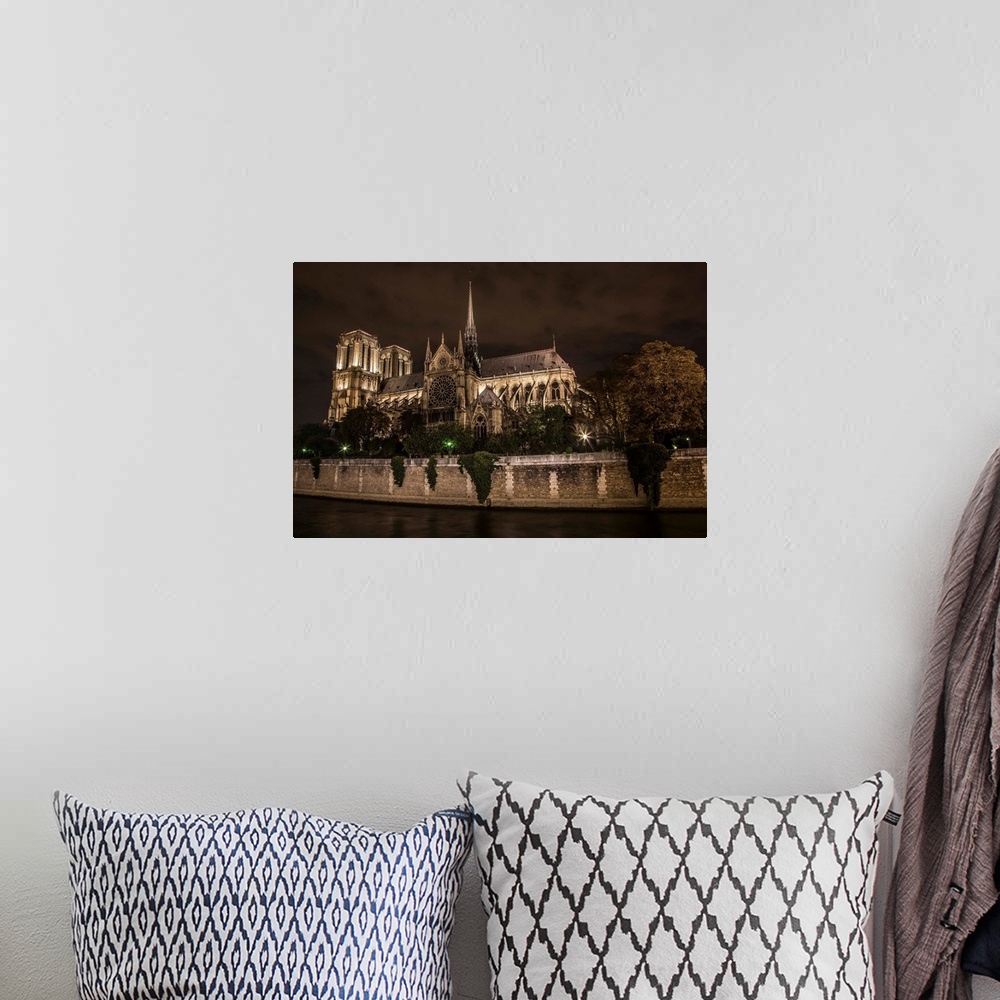 A bohemian room featuring The Notre Dame Cathedral in Paris at night
