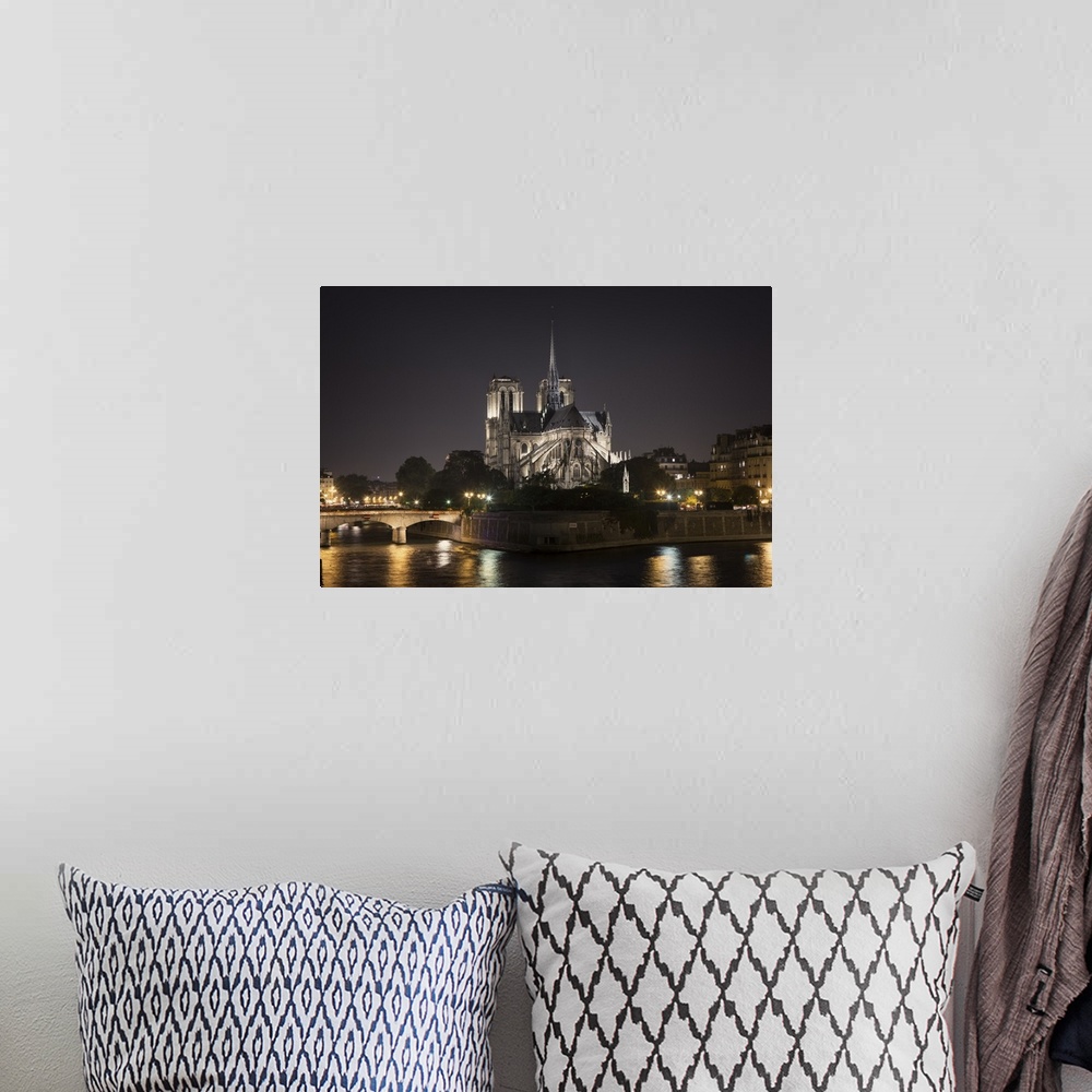 A bohemian room featuring The Notre Dame Cathedral in Paris at night