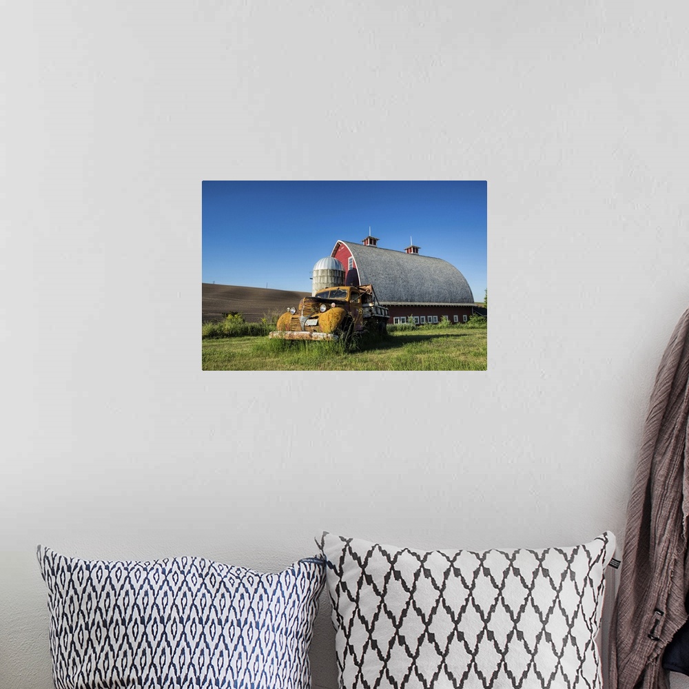 A bohemian room featuring Vintage pickup truck and red barn in the Palouse region of Washington State