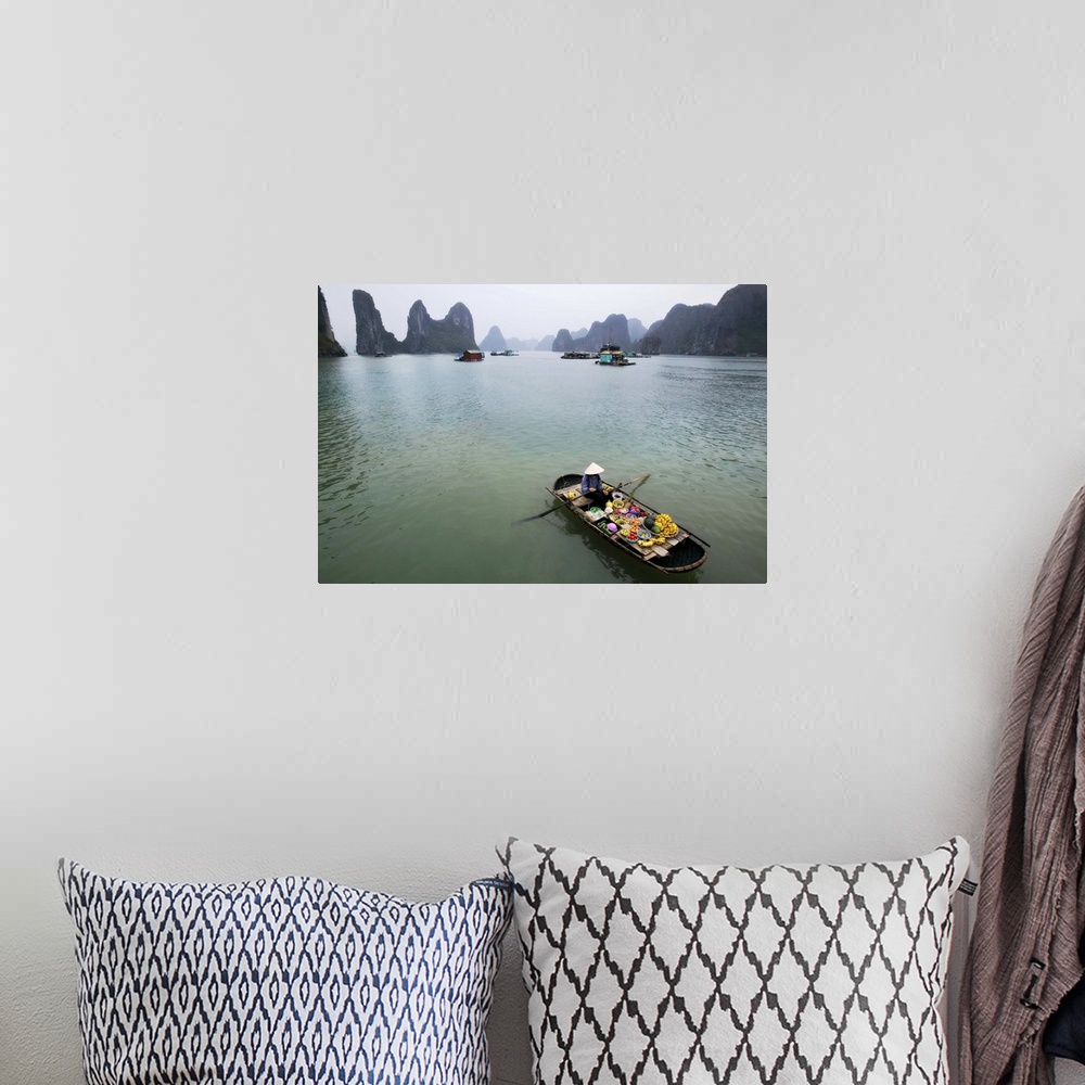 A bohemian room featuring Woman selling fruit by her floating village, Halong Bay, Vietnam