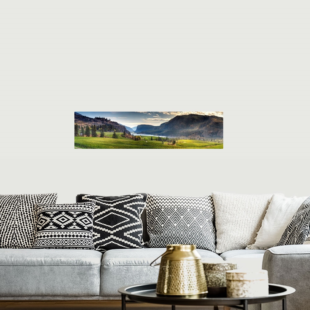 A bohemian room featuring A rolling vineyard with beautiful mountains and landscape located in the Okanagan Valley, Canada.