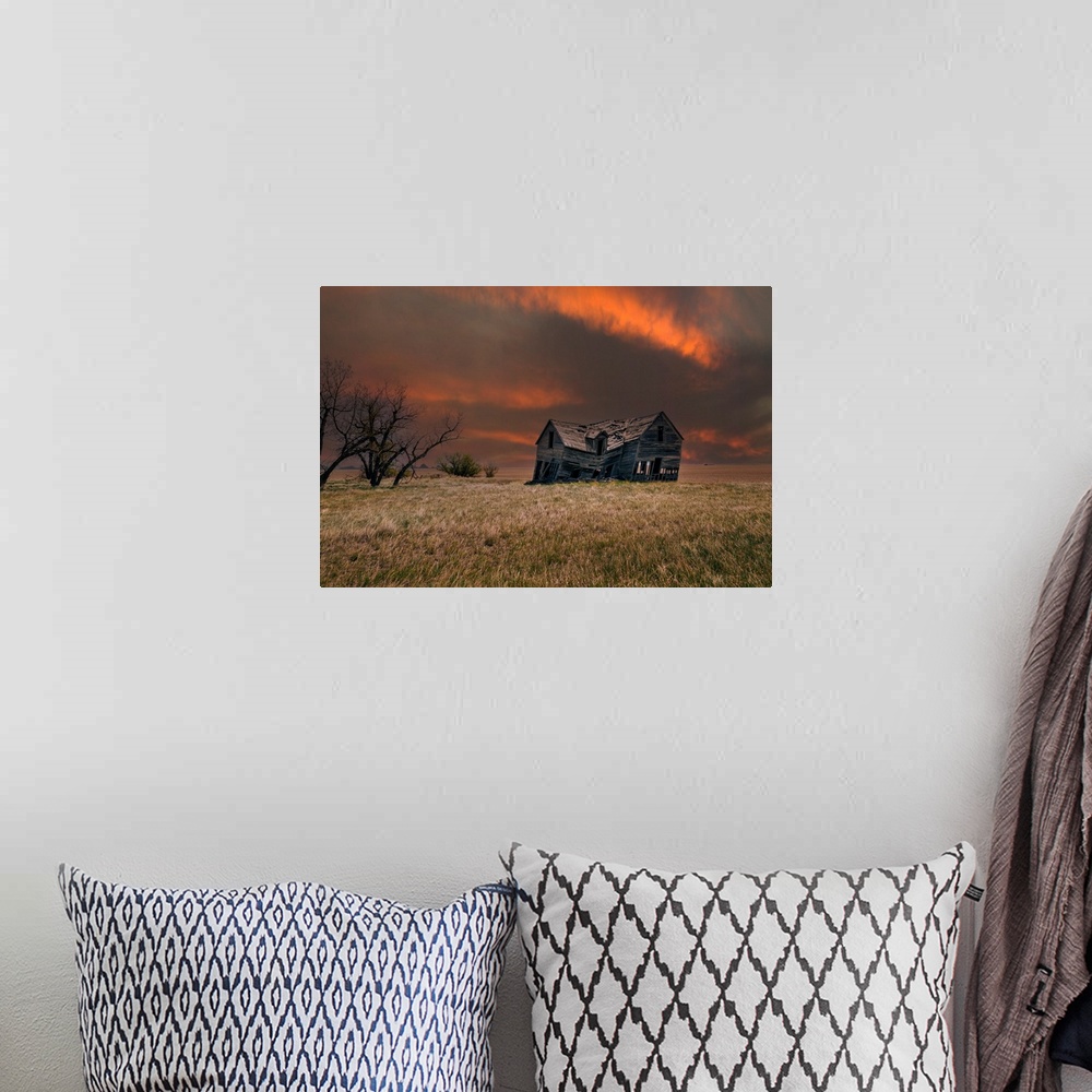 A bohemian room featuring An old abandoned farm house with stormy skies at sunset in the Canadian prairies.
