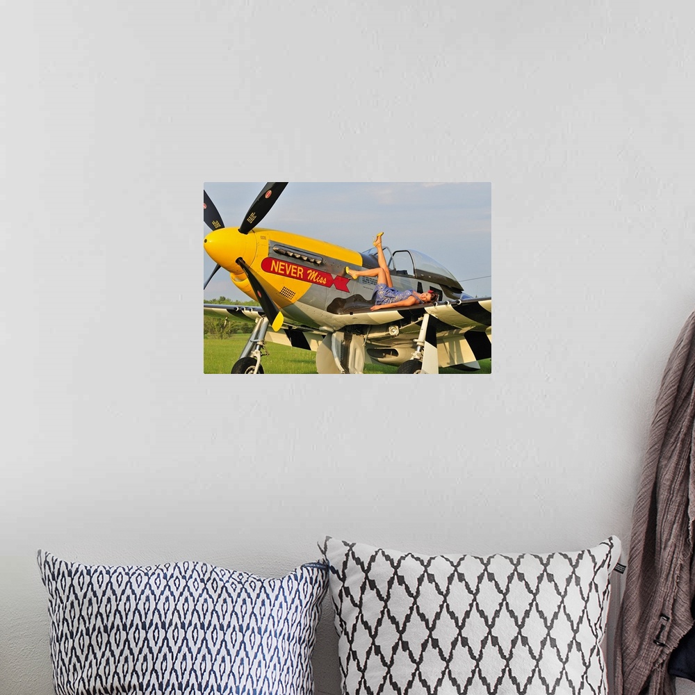 A bohemian room featuring 1940's style pin-up girl lying on the wing of a P-51 Mustang fighter plane.