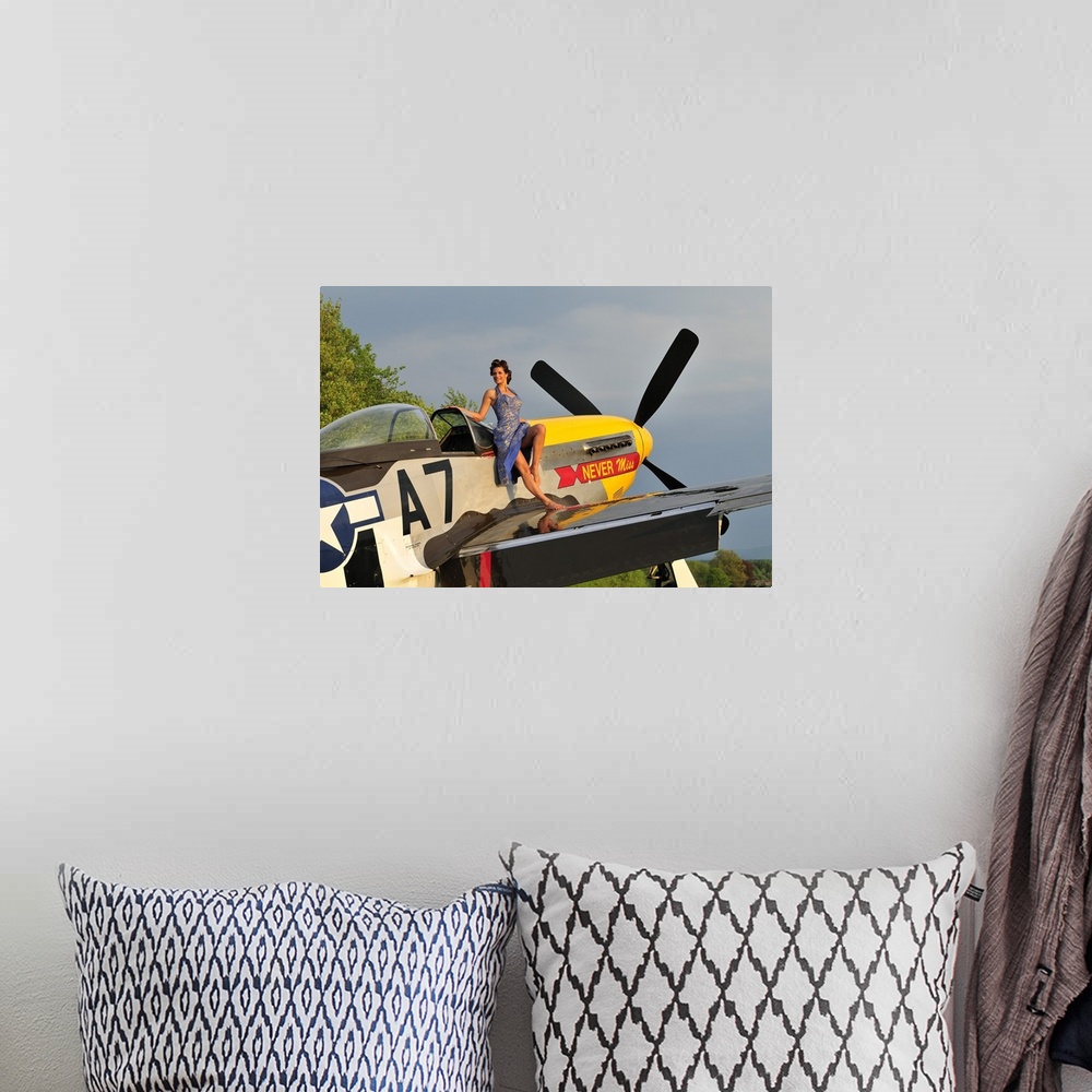 A bohemian room featuring Beautiful 1940's style pin-up girl standing barefoot on the wing of a P-51 Mustang.