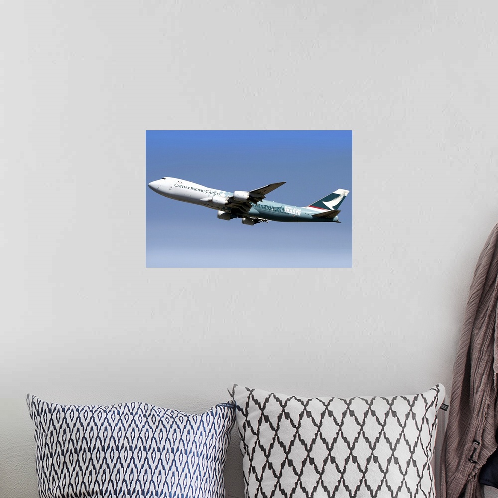 A bohemian room featuring A Boeing 747-800 Cathay Pacific Cargo Hong Kong Trader in flight over Italy.