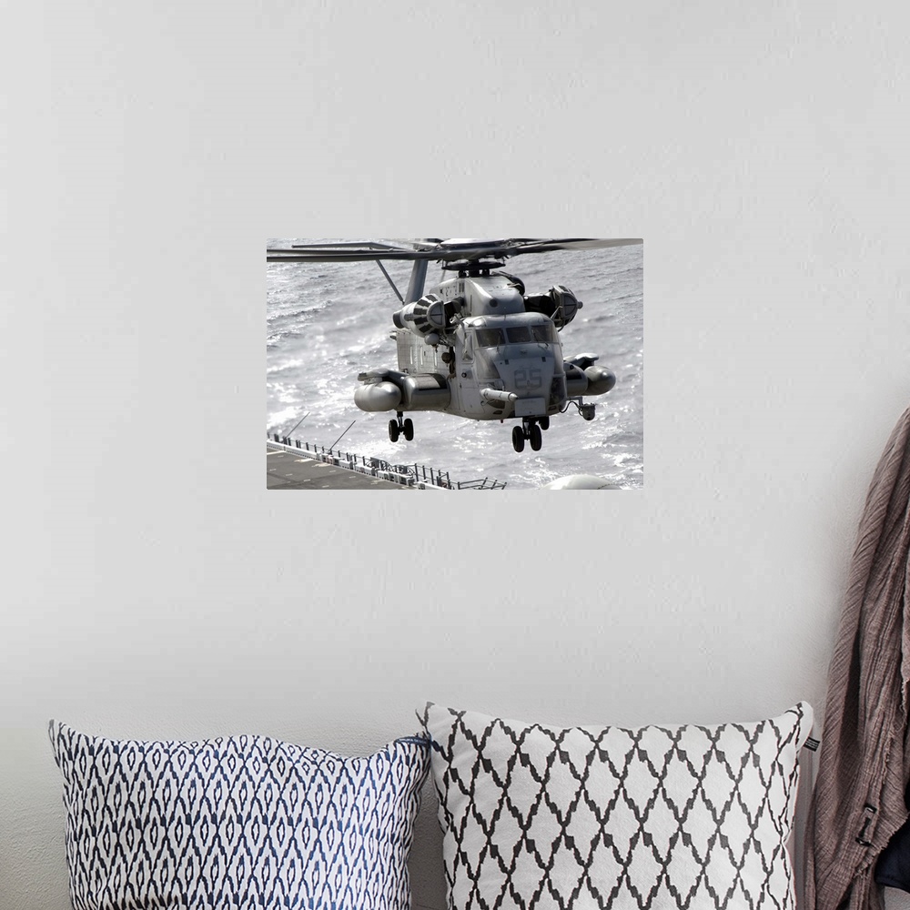 A bohemian room featuring A CH53E Super Stallion helicopter takes off from USS Makin Island