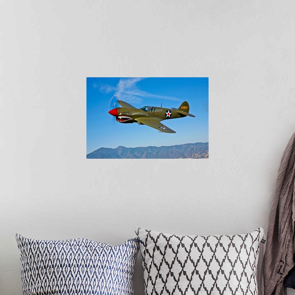A bohemian room featuring A Curtiss P-40E Warhawk in flight near Chino, California.