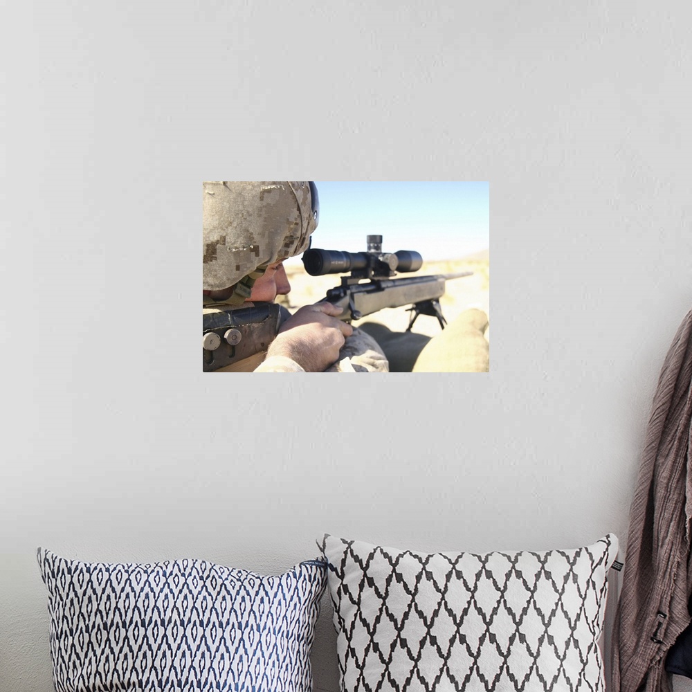 A bohemian room featuring A soldier aims in with his M40A3 Scout Sniper Rifle