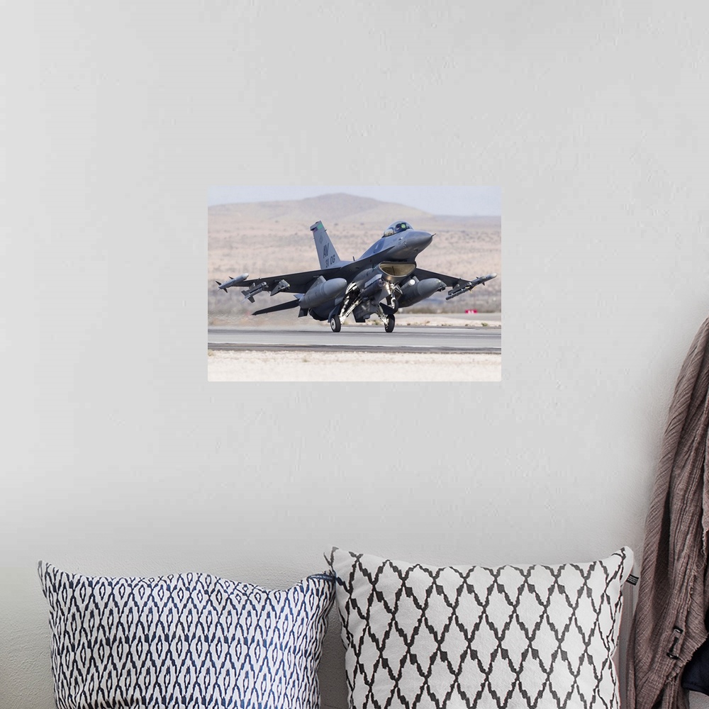 A bohemian room featuring A U.S. Air Force F-16C Fighting Falcon landing at Nellis Air Force Base, Nevada.