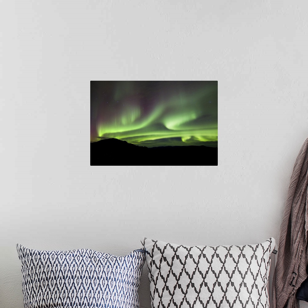 A bohemian room featuring Aurora borealis over Gray Peak, Whitehorse, Yukon Canada.