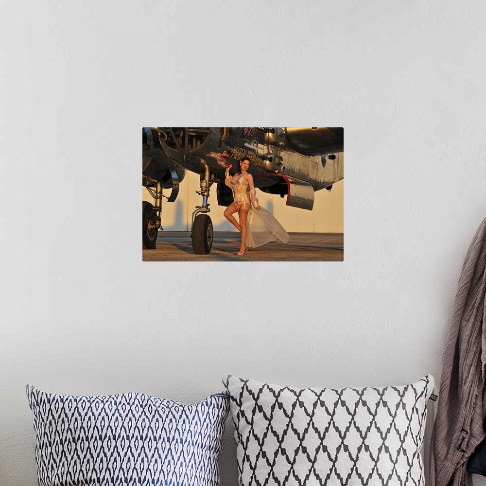 A bohemian room featuring Beautiful 1940's pin-up girl standing with a B-25 bomber.