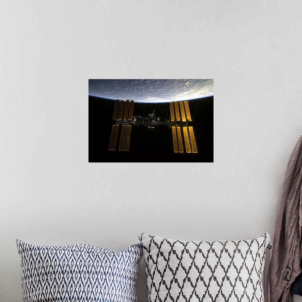 A bohemian room featuring International Space Station backdropped against Earths horizon