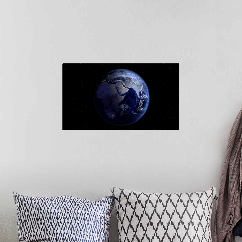 A bohemian room featuring Planet Earth showing Africa, Europe and Asia, half night and half day with city lights