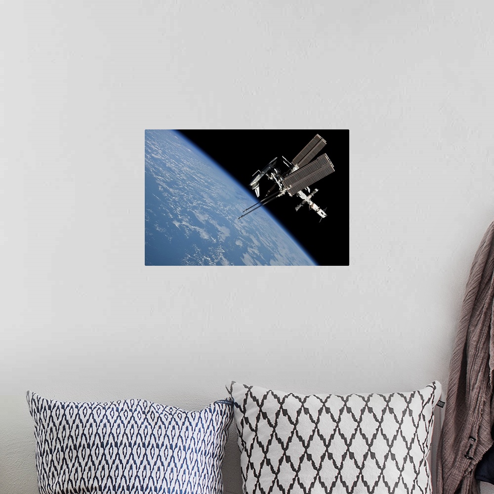A bohemian room featuring May 23, 2011 - The International Space Station and docked Space Shuttle Endeavour, backdropped by...