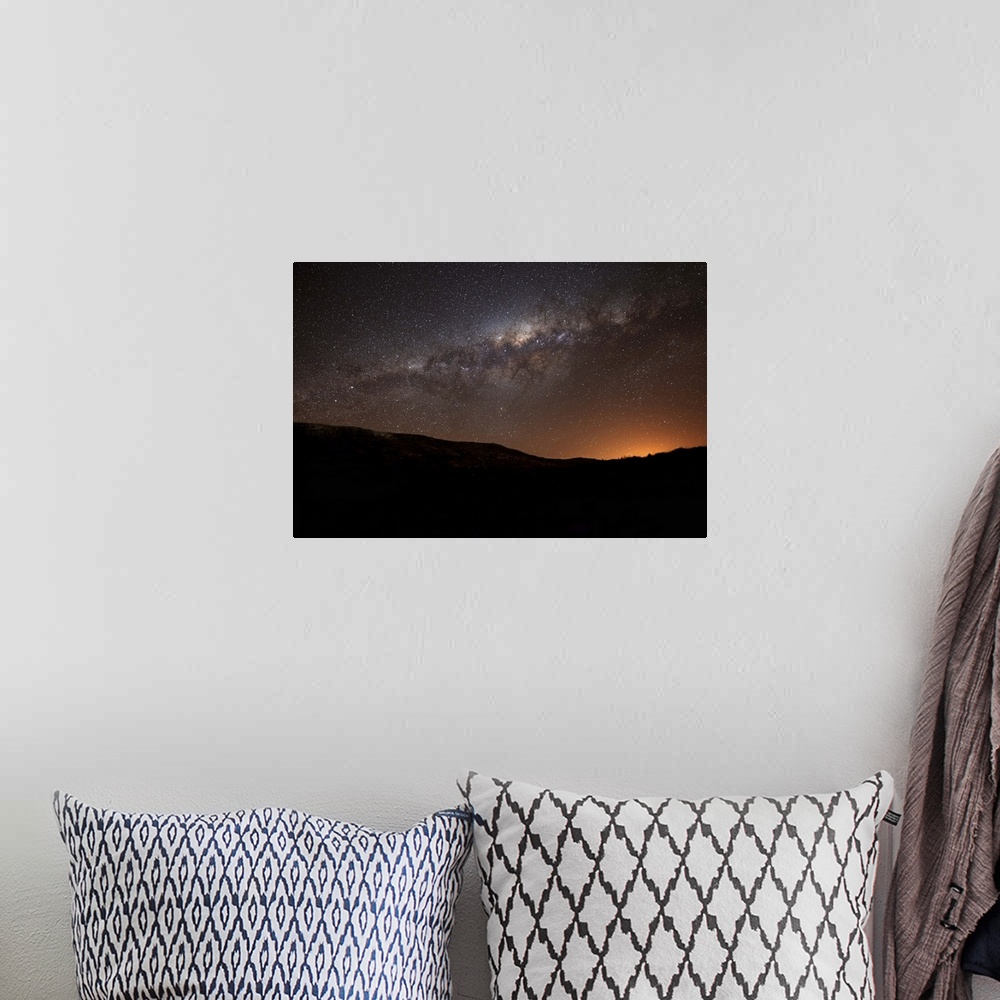 A bohemian room featuring The Milky Way setting behind the hills of Azul, Argentina, part of the Tandilia Hills. The light ...
