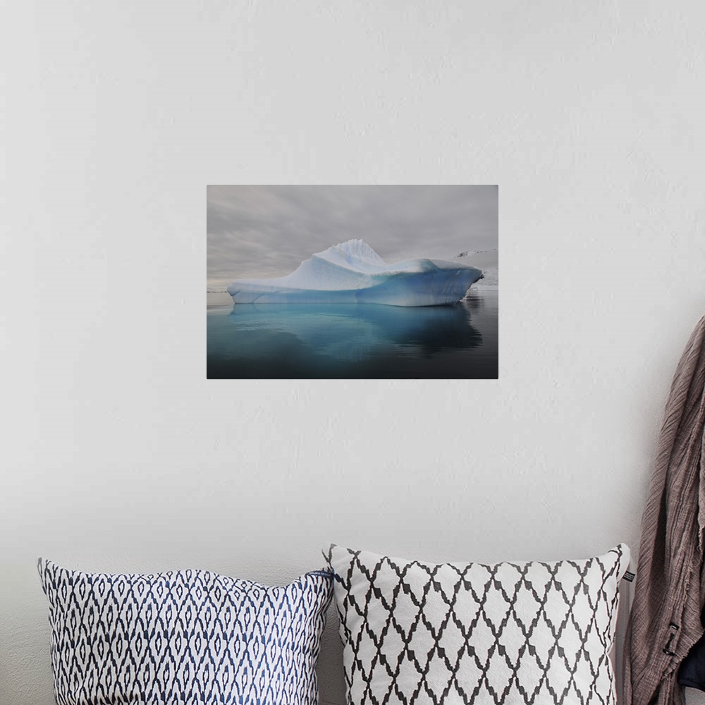 A bohemian room featuring Translucent blue iceberg reflection, Antarctica.