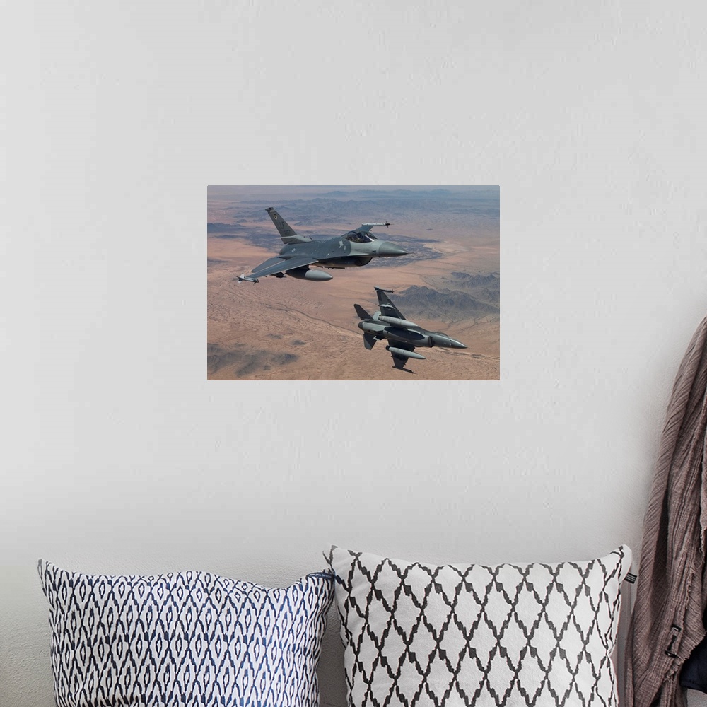 A bohemian room featuring Two F-16's from the 56th Fighter Wing at Luke Air Force Base, Arizona, manuever on a training mis...