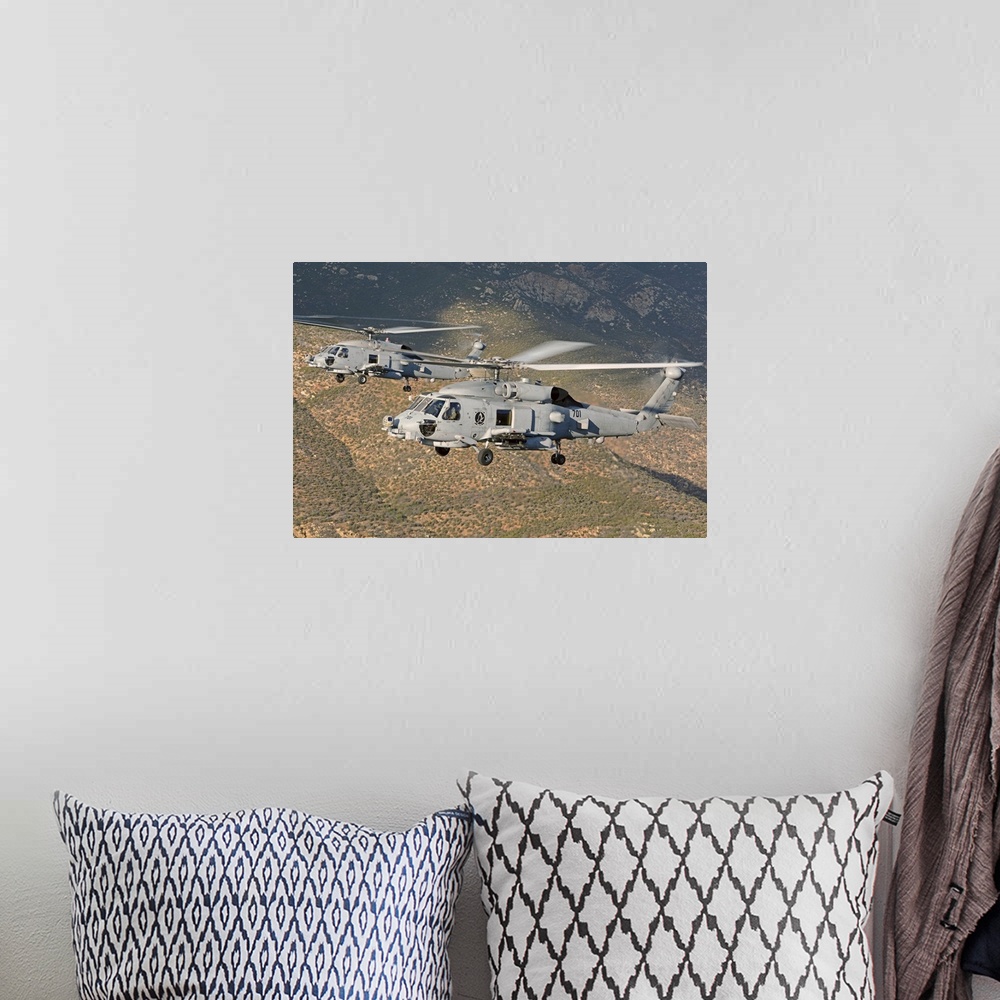 A bohemian room featuring Two MH-60 helicopters of the U.S. Navy Blue Hawks squadron flying over Fallon, Nevada.
