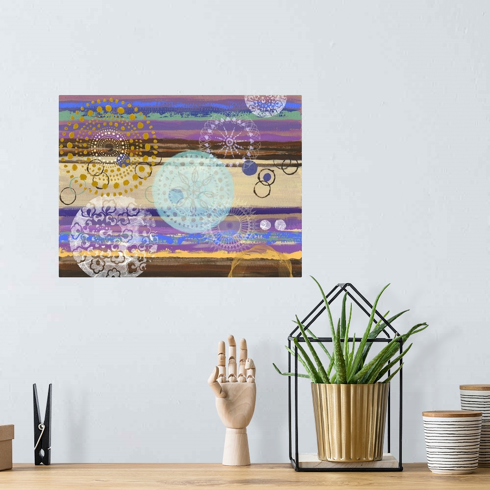 A bohemian room featuring Abstract artwork of horizontal layers of yellow and purple, embellished with circular prints.