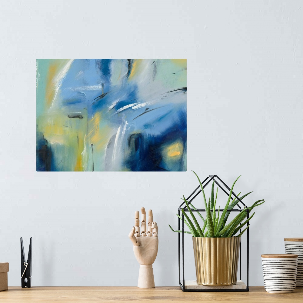 A bohemian room featuring Large blue, green, and yellow abstract painting with black and white brushstrokes on top creating...