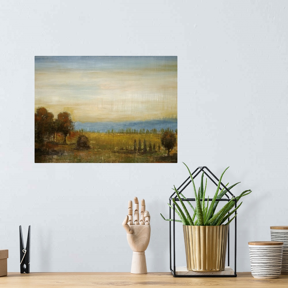 A bohemian room featuring Painting on canvas of a field with a bunch of trees and a rolling hill in the distance.