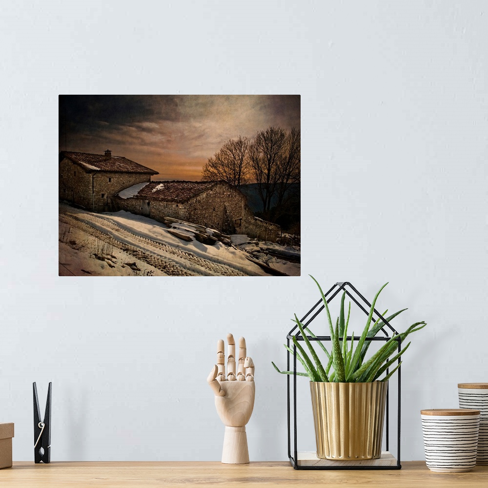 A bohemian room featuring A winter scene with snow of an old house at dusk